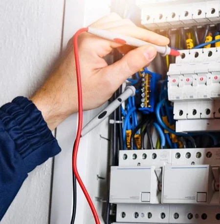 electrician inspecting fuse box