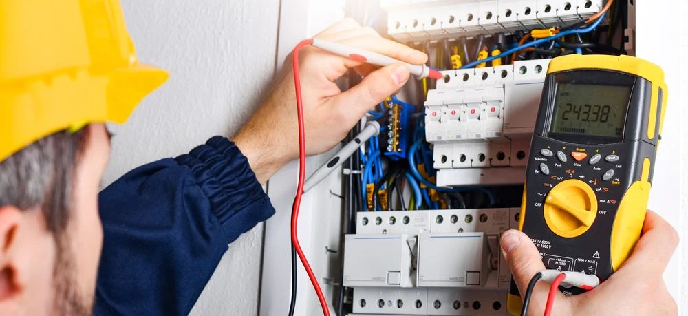 electrician inspecting fuse box